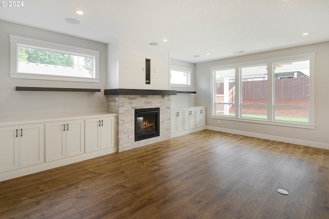 unfurnished living room with dark wood-type flooring