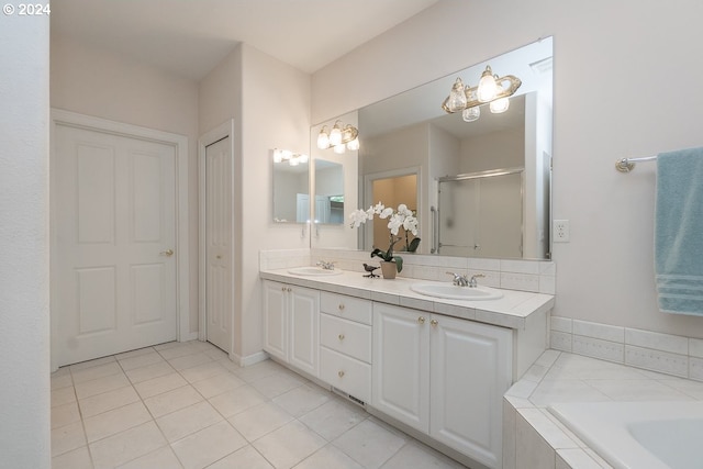 bathroom with tile patterned flooring, shower with separate bathtub, and vanity