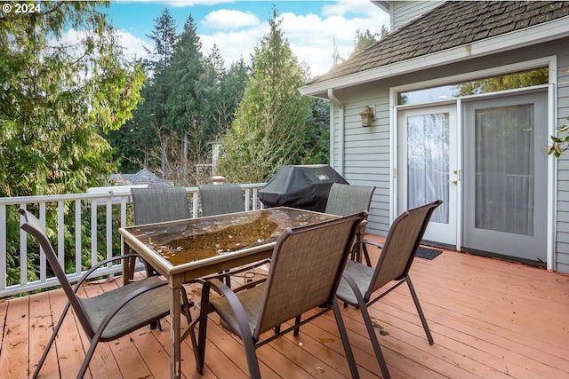 wooden deck with a grill