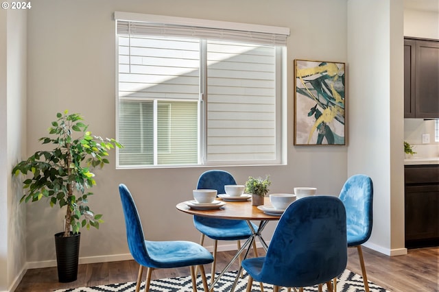 dining space with hardwood / wood-style flooring