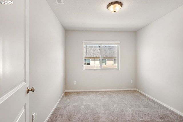 empty room featuring light carpet