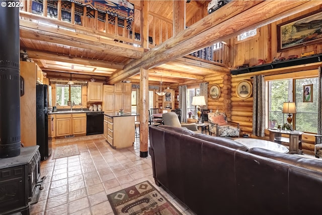 living room with a high ceiling, light tile floors, rustic walls, and plenty of natural light