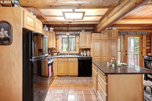 kitchen with light brown cabinets, a center island, sink, beam ceiling, and black appliances