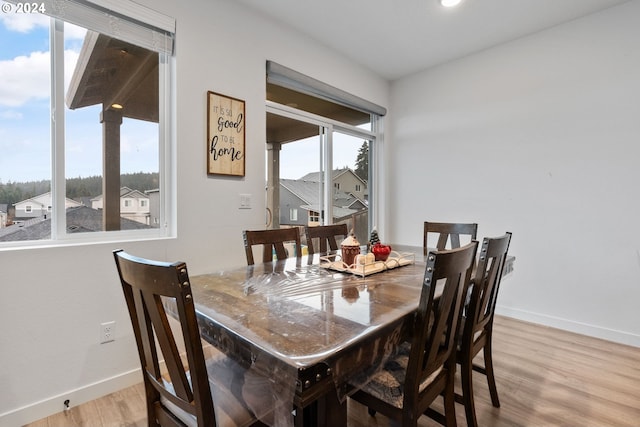 dining area featuring light wood-type flooring and a wealth of natural light