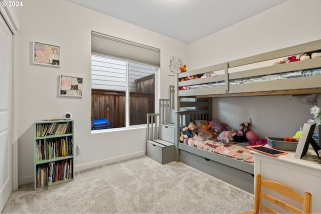 bedroom with carpet and baseboards