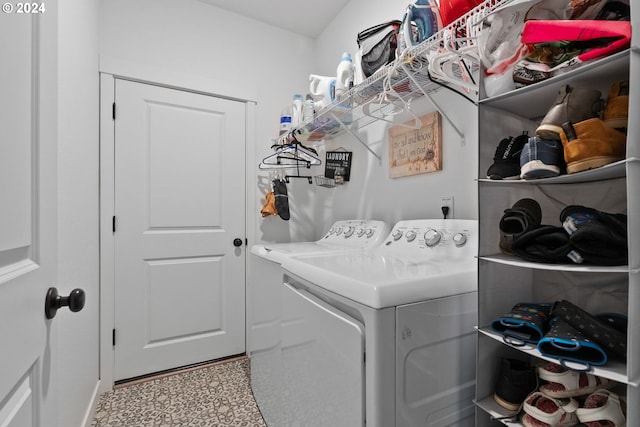 laundry area with washing machine and dryer and baseboards