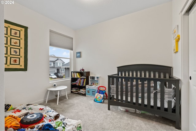 carpeted bedroom with a nursery area