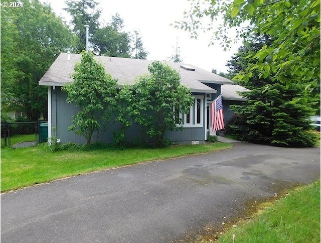 view of property exterior with a lawn