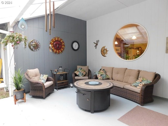 living room with wooden walls and concrete flooring