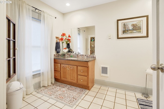 bathroom featuring toilet, vanity, baseboards, visible vents, and tile patterned floors