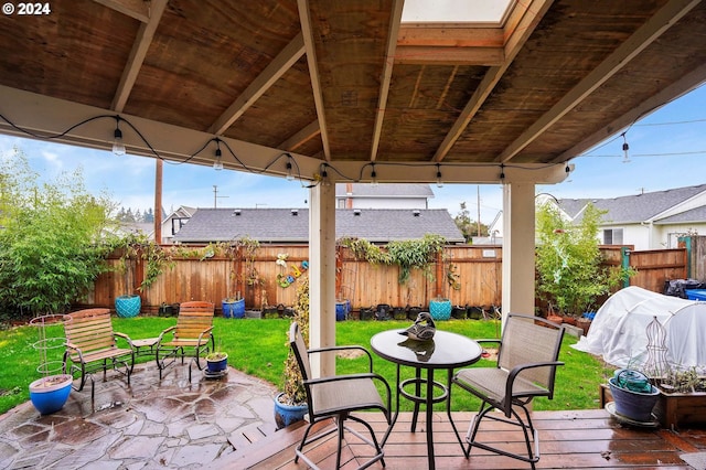 view of patio with a deck, a gazebo, fence, and a grill