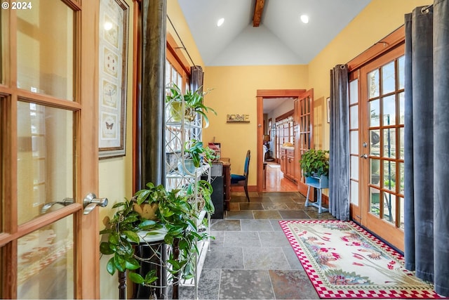 entryway with vaulted ceiling with beams, recessed lighting, stone tile floors, baseboards, and french doors