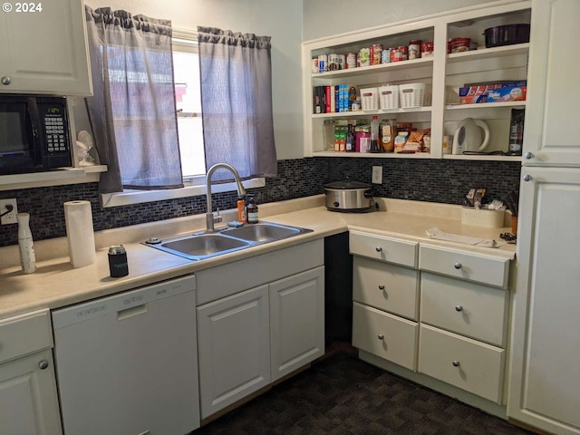 kitchen with tasteful backsplash, black microwave, white cabinets, sink, and dishwasher