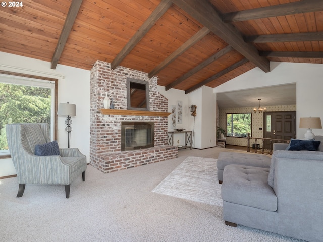 living room featuring vaulted ceiling with beams, a fireplace, wood ceiling, carpet flooring, and a chandelier