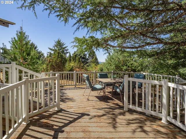 wooden terrace featuring outdoor dining space