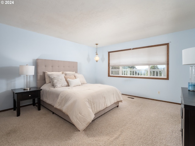 carpeted bedroom featuring visible vents and baseboards