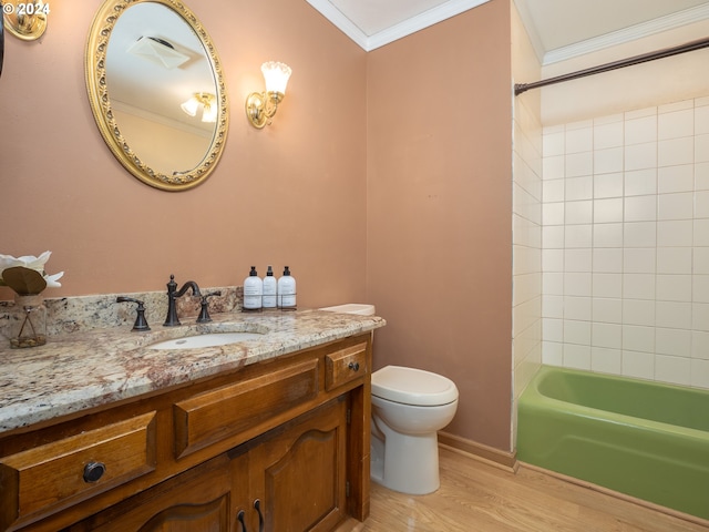 bathroom featuring toilet, vanity, ornamental molding, wood finished floors, and shower / bathtub combination