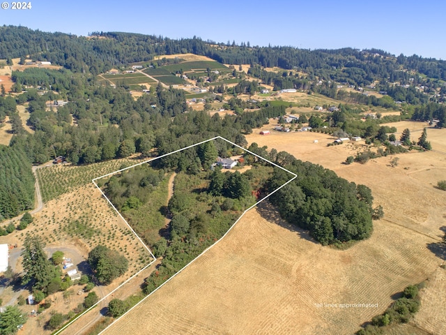 drone / aerial view featuring a rural view and a wooded view