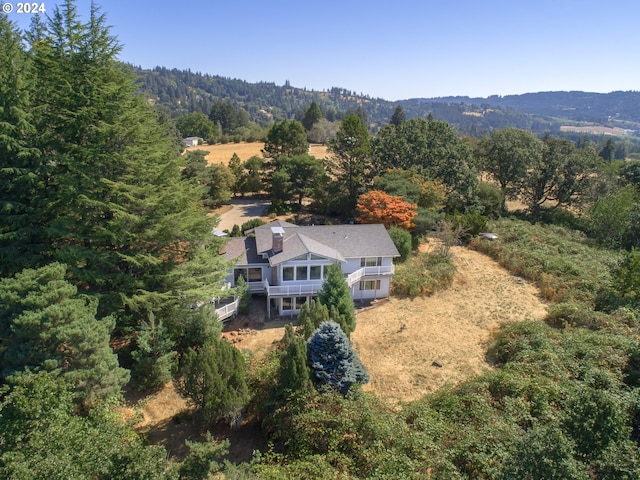 bird's eye view with a wooded view