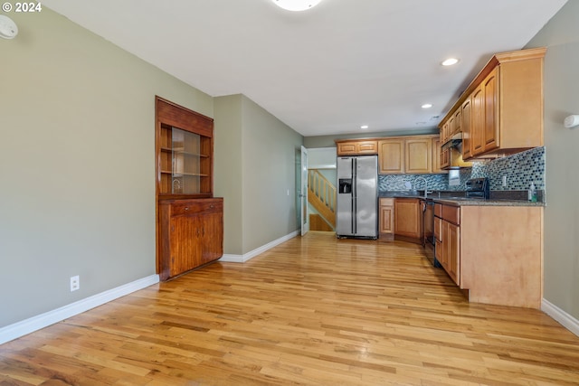 kitchen featuring decorative backsplash, stainless steel fridge with ice dispenser, light hardwood / wood-style flooring, and dishwasher