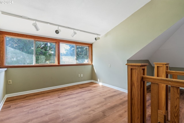 additional living space with light hardwood / wood-style floors