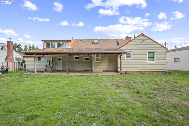 rear view of property with a yard and a patio