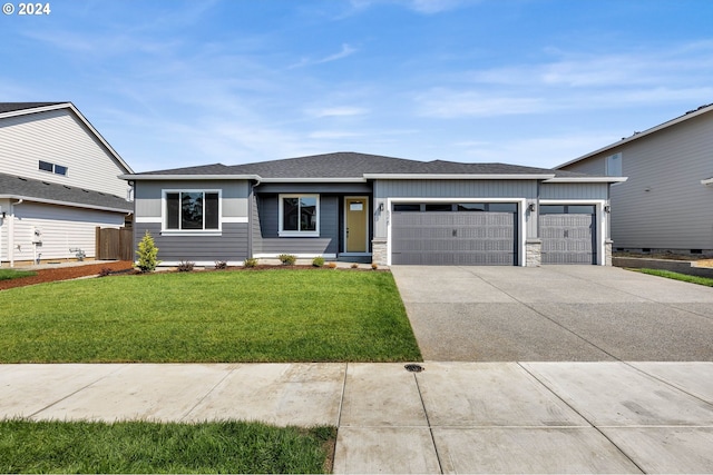 view of front of property featuring a garage and a front yard