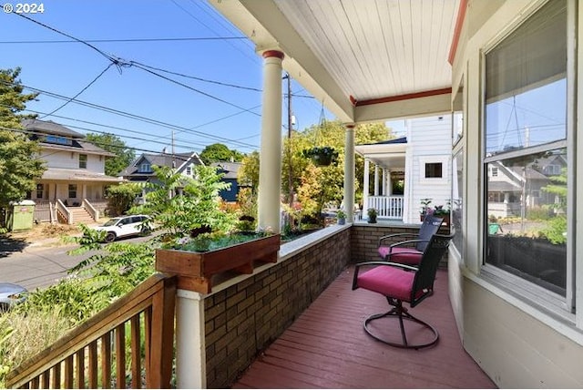 wooden terrace featuring covered porch