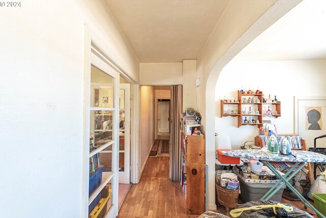 corridor with hardwood / wood-style flooring