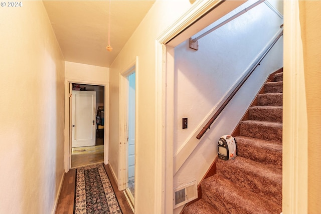 corridor with hardwood / wood-style flooring