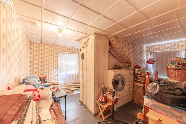 bedroom featuring wood-type flooring and a drop ceiling