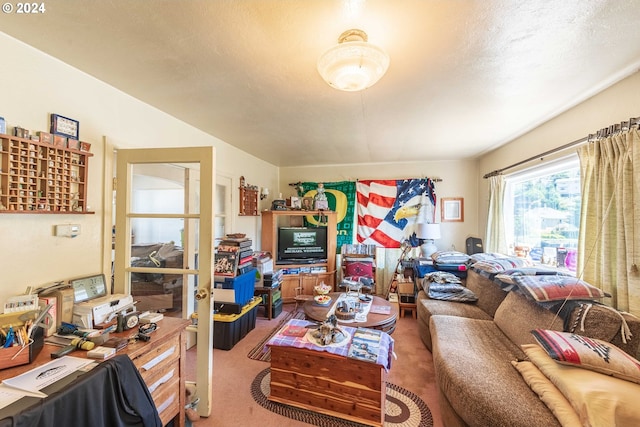 carpeted living room featuring a textured ceiling