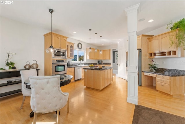 kitchen with pendant lighting, a center island, stainless steel appliances, light brown cabinetry, and light hardwood / wood-style flooring