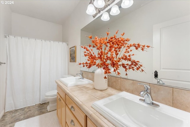 bathroom with curtained shower, vanity, and toilet