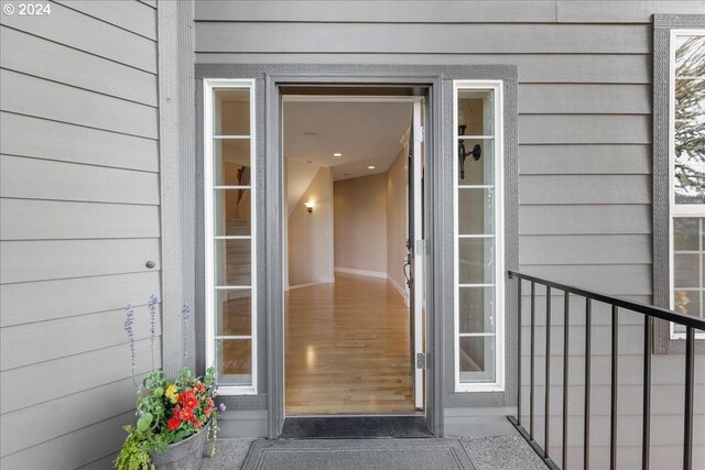 foyer featuring wood-type flooring and a high ceiling