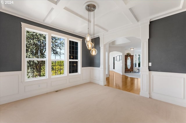 empty room featuring beam ceiling, carpet, and coffered ceiling