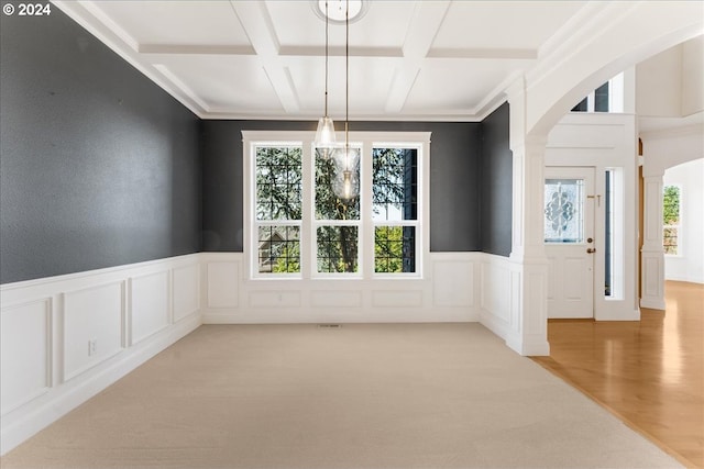 unfurnished dining area with coffered ceiling and carpet flooring