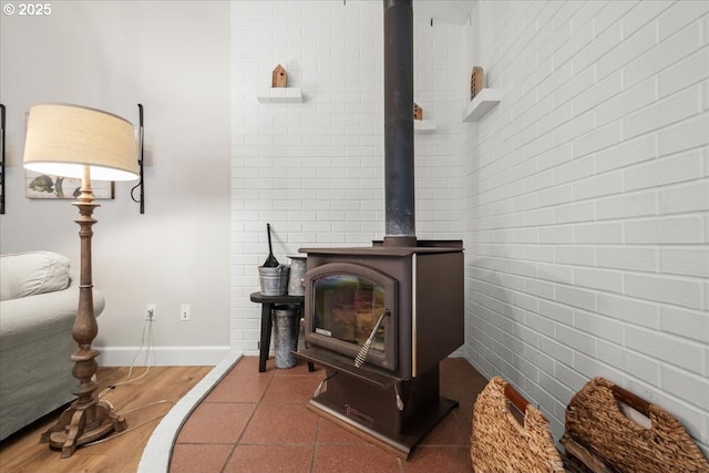 details featuring a wood stove and baseboards