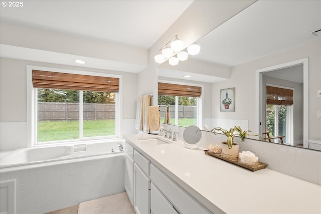 full bathroom with a bath, visible vents, a wealth of natural light, and vanity