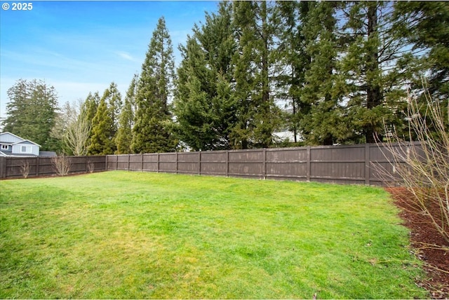 view of yard with a fenced backyard