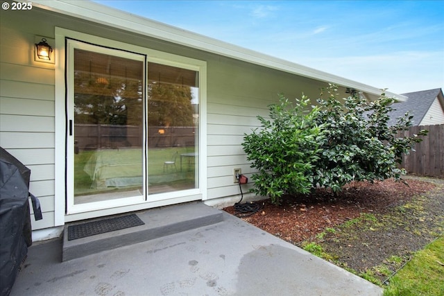 view of exterior entry with fence