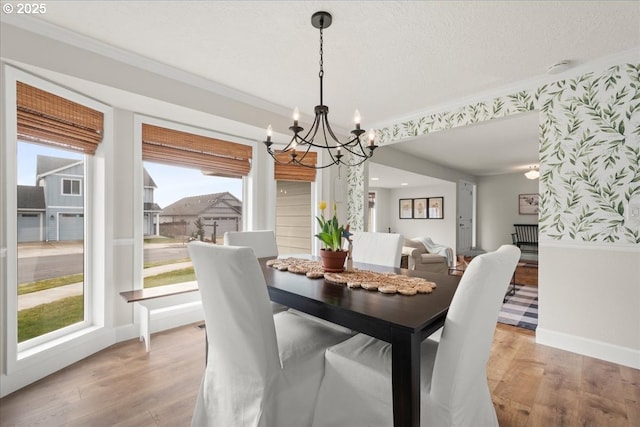 dining space featuring light wood finished floors and crown molding