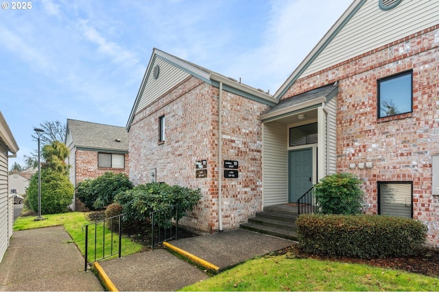 view of exterior entry featuring a yard