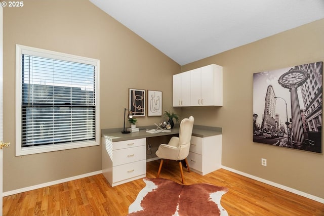 office featuring light hardwood / wood-style floors and lofted ceiling