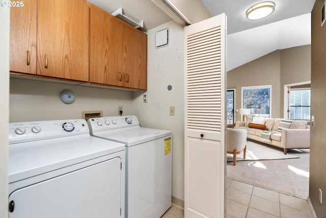 washroom with cabinets, light colored carpet, and separate washer and dryer