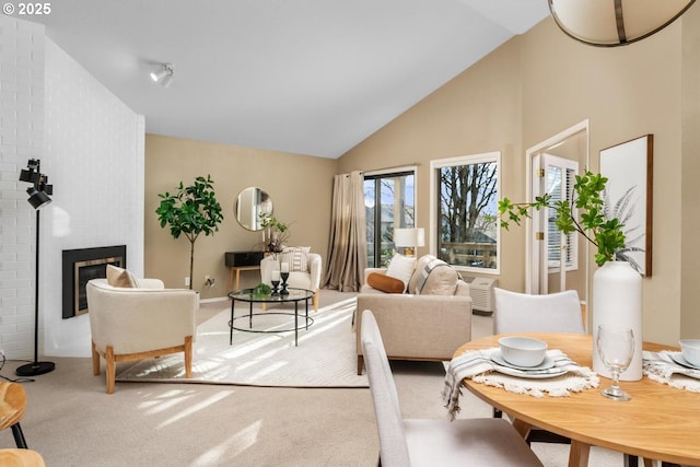 carpeted living room featuring a fireplace and high vaulted ceiling