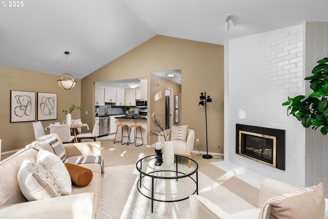 carpeted living room with sink, lofted ceiling, and a fireplace