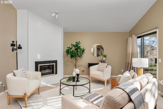 living room featuring light carpet, a large fireplace, and vaulted ceiling