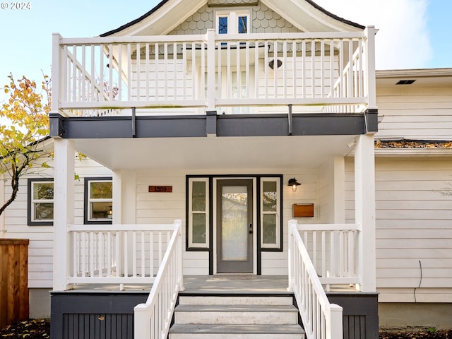 view of front of home with a balcony and covered porch