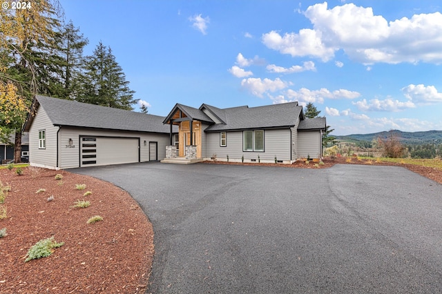 view of front facade featuring a garage and aphalt driveway